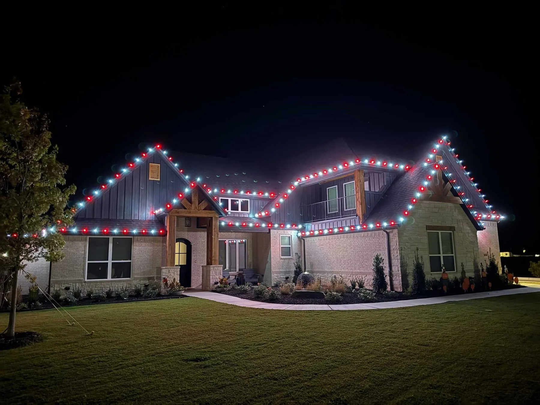 Red and white roofline lighting on a craftsman-style home
